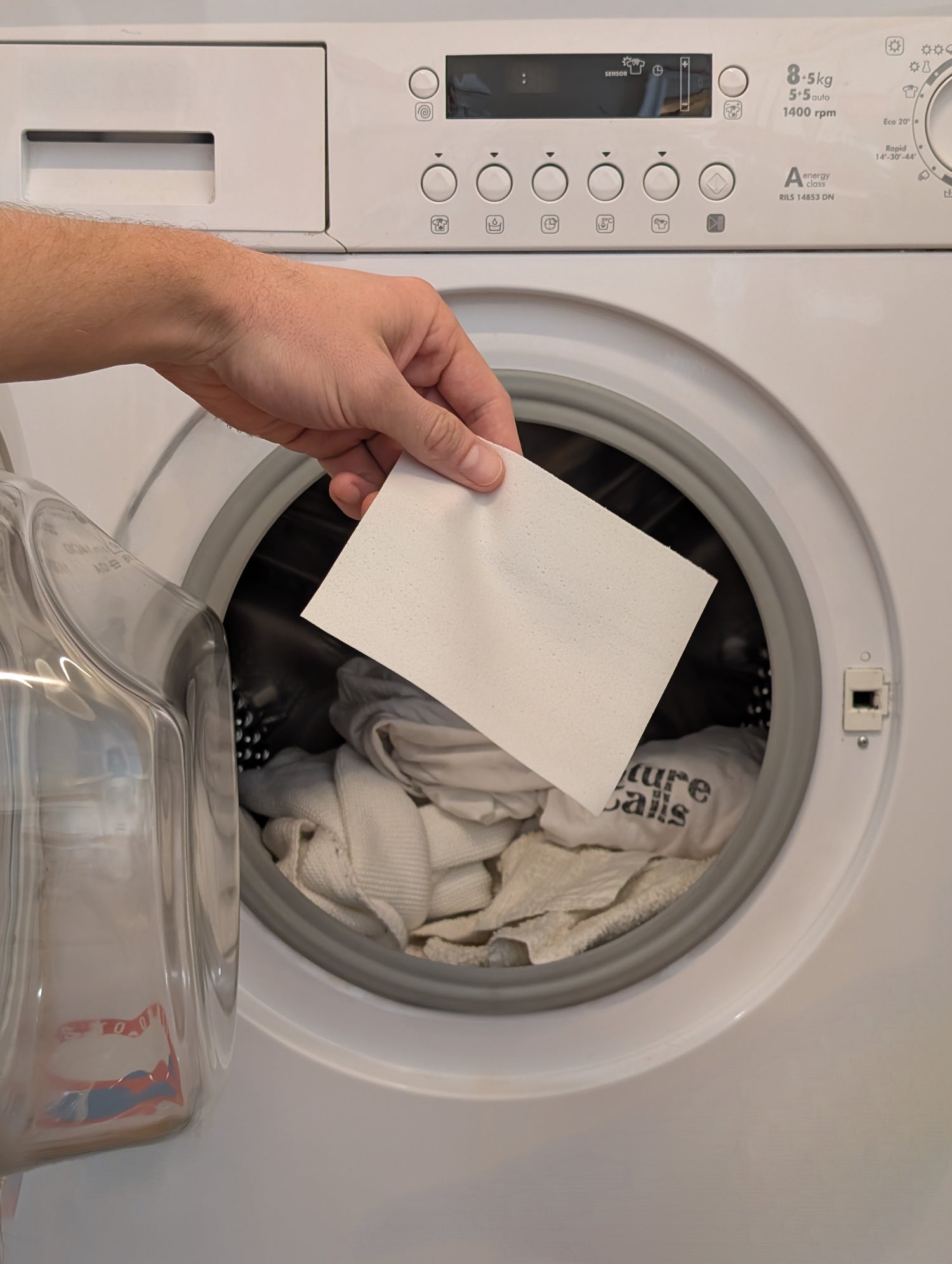Nature Calls eco-friendly Laundry Detergent Sheet being placed into a washing machine